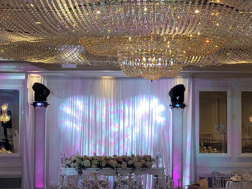 DJ Mario wedding setup with moving head lights and crystal chandeliers