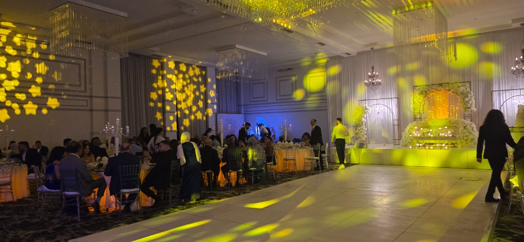 Wedding reception with yellow and gold lighting effects