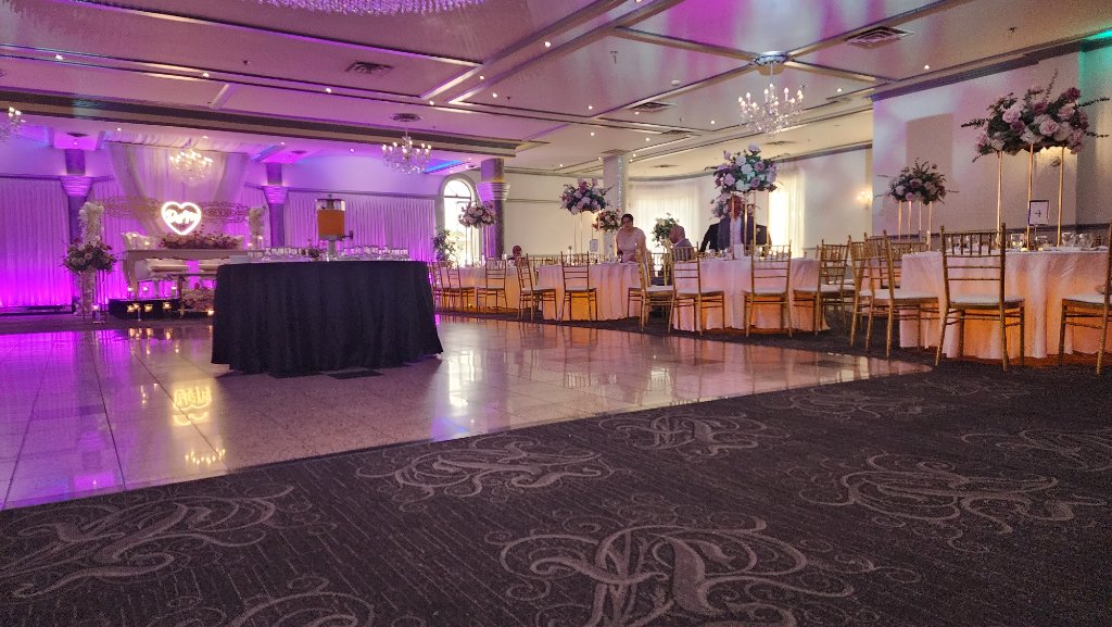 Elegant wedding ballroom with pink uplighting