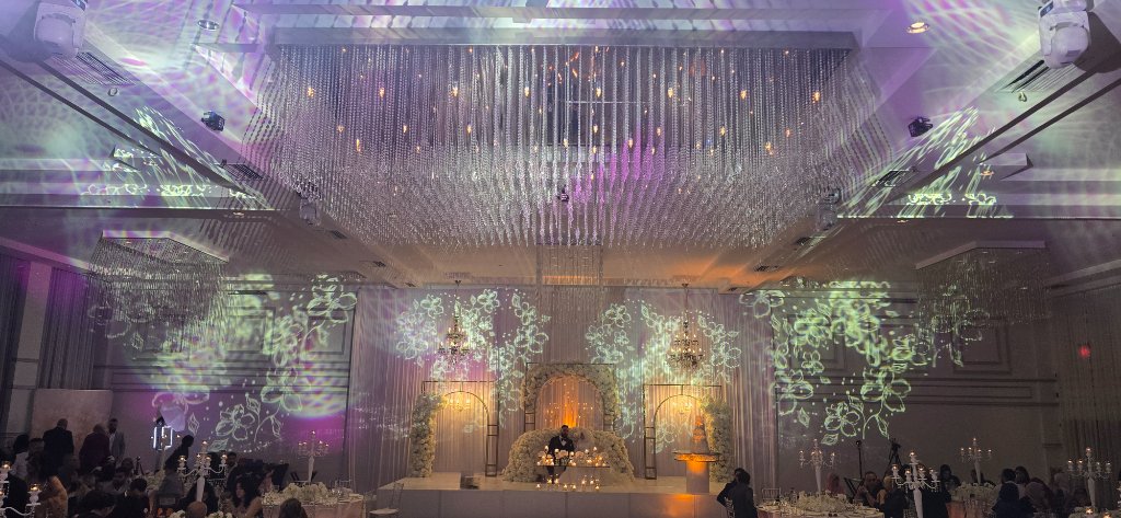Grand wedding hall with crystal chandelier and floral projections