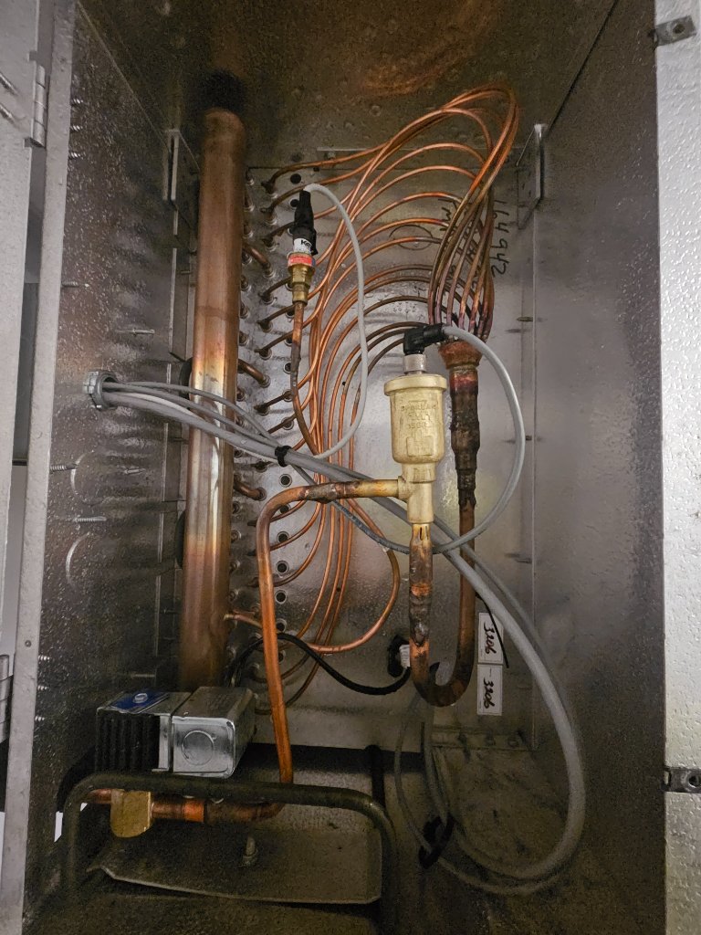 TXV valve and evaporator coil internals during refrigerant system inspection