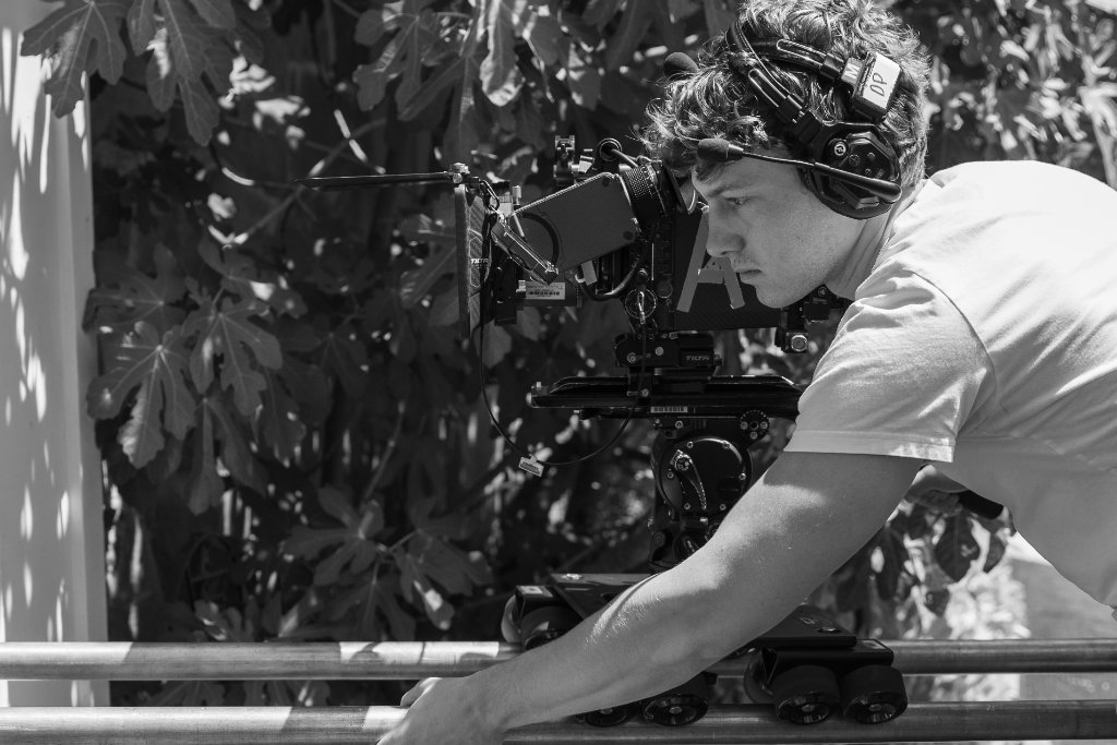 Abraham Balser on set with a film camera