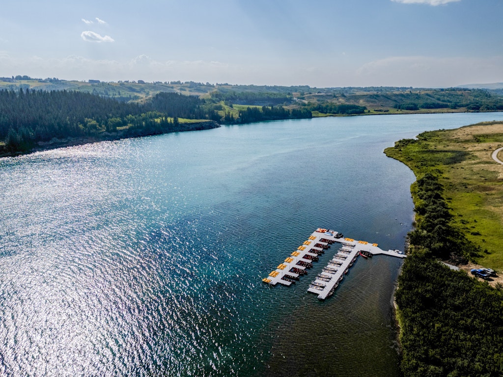 Aerial view of walking trail leading to Bearspaw Marina on Bearspaw Reservoir, accessed via Haskayne Legacy Park near Calgary