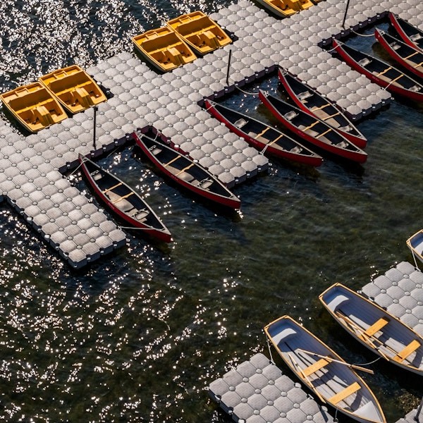 Colourful fleet of kayaks, canoes and pedal boats ready for rental at Bearspaw Marina on Bearspaw Reservoir near Calgary