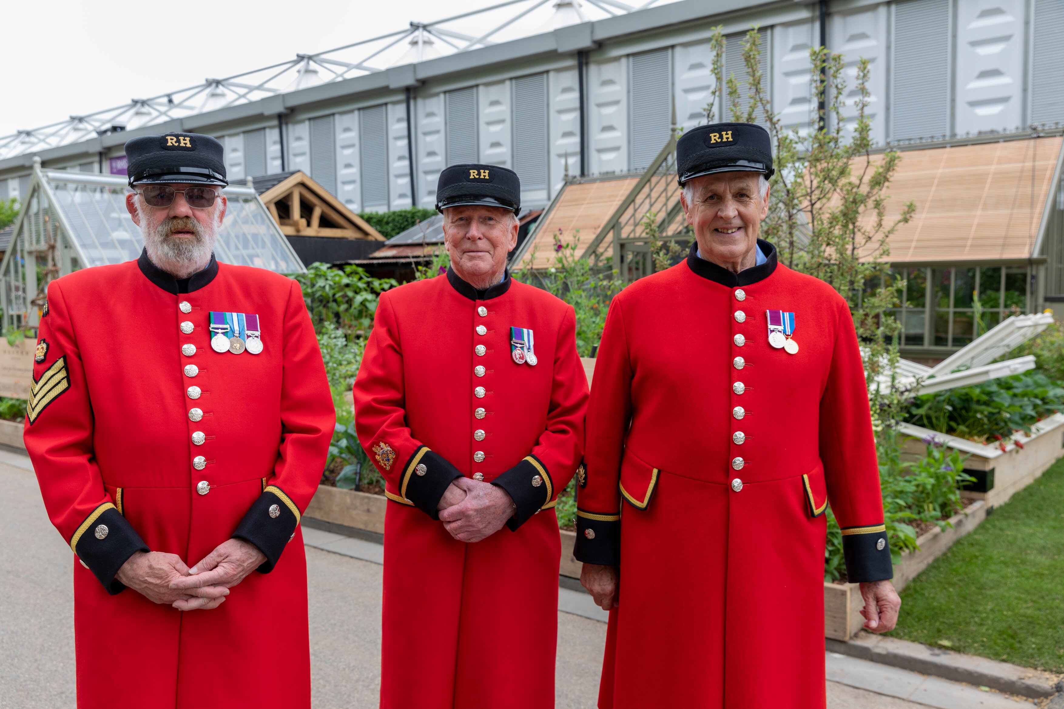 Three Chelsea Pensioners in their scarlet uniforms at the RHS Chelsea Flower Show.