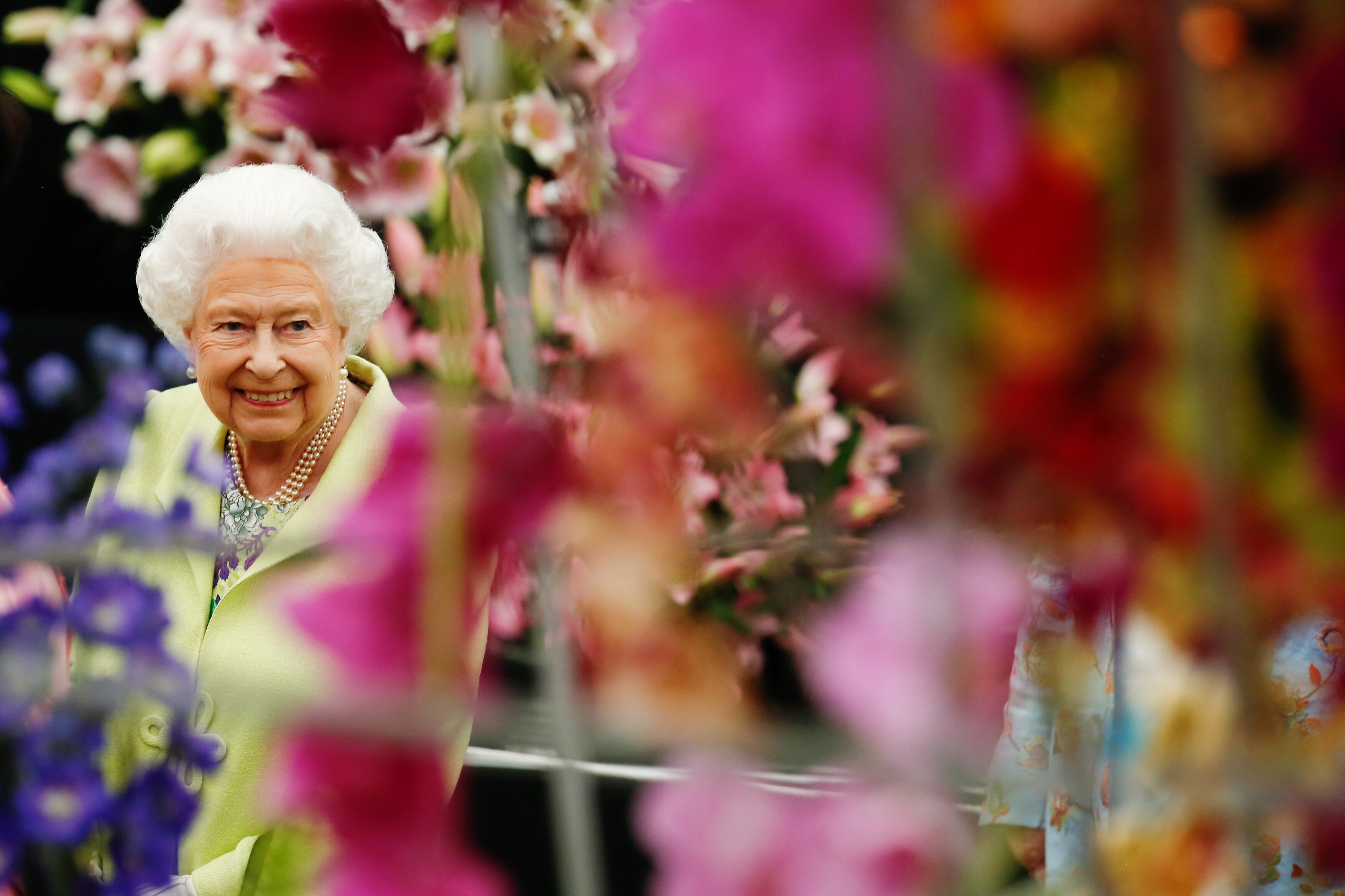 The late Queen Elizabeth II smiling among flowers at the RHS Chelsea Flower Show, 2019.