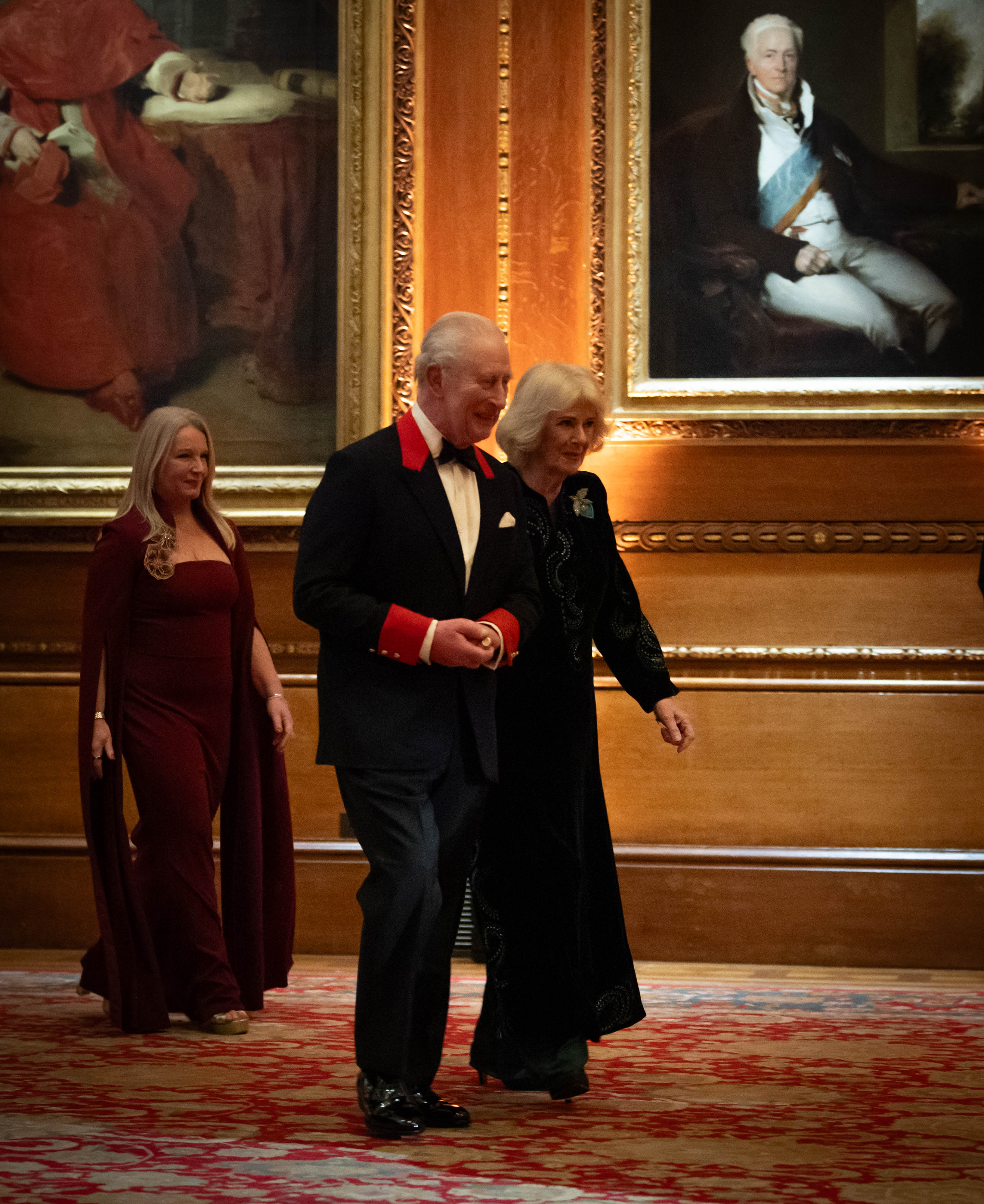 The King and Queen walking together at the premiere of Finding Harmony: A King’s Vision.