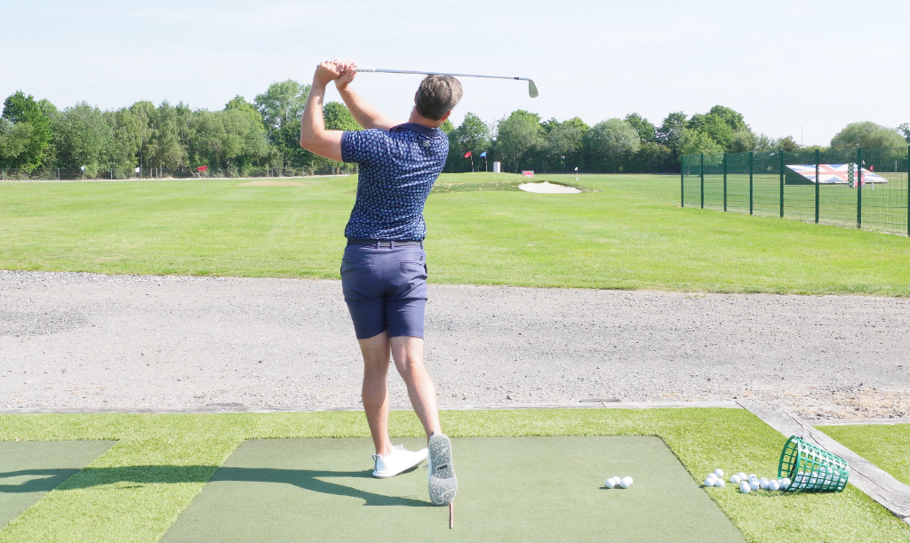 Golfer practising at the Calderfields driving range