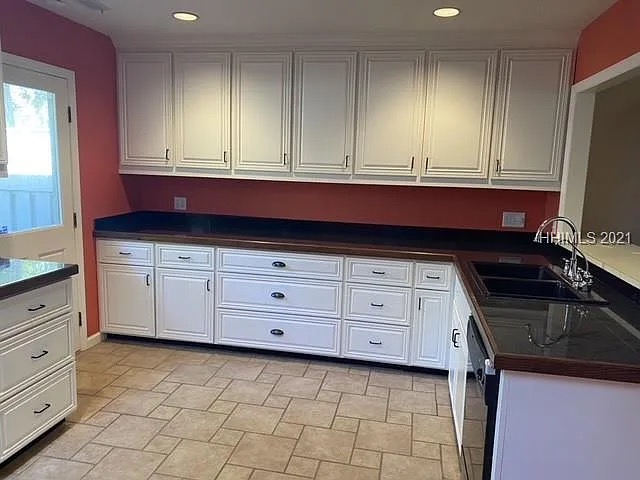 Dated kitchen with red walls and basic cabinetry before Blueprint Construction renovation — Golden Isles, GA