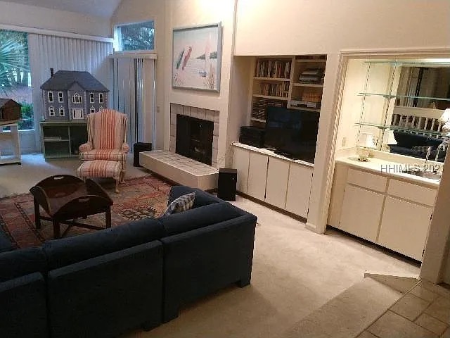 Dated living room with basic furniture and outdated built-ins before Blueprint Construction renovation — Golden Isles, GA