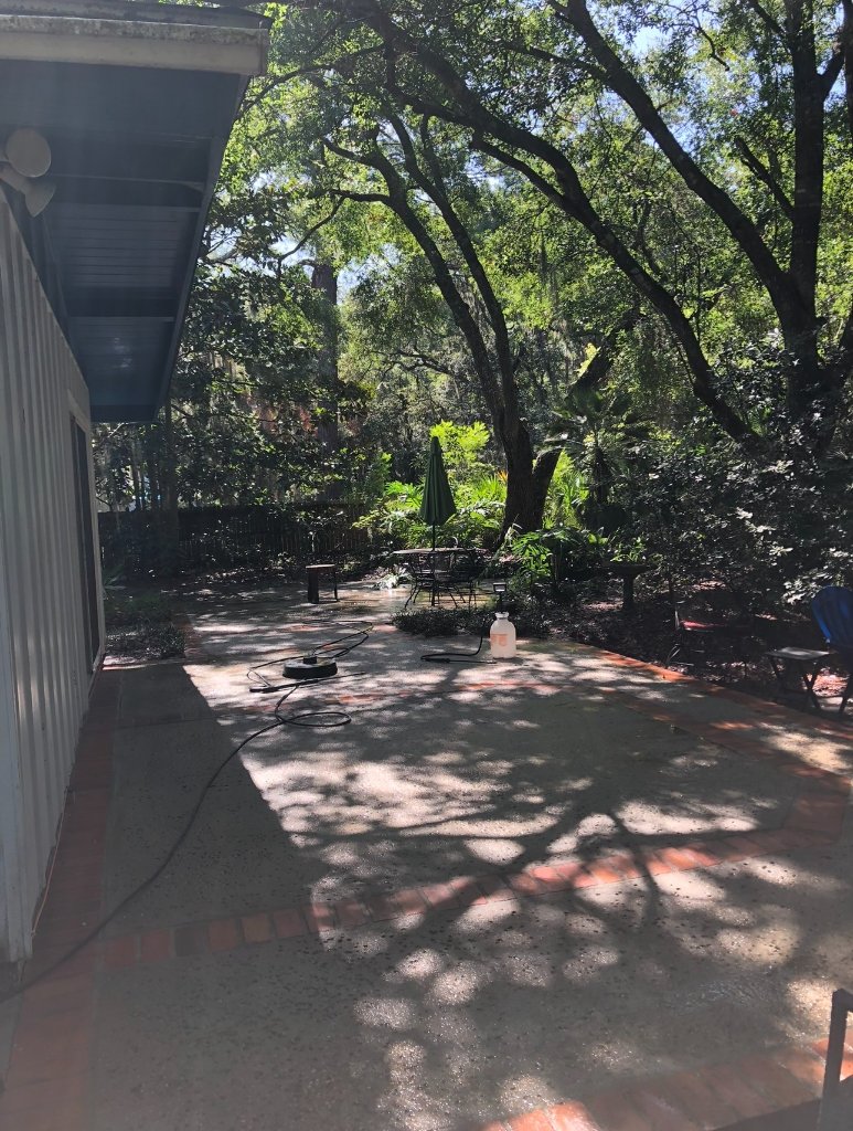 Bright restored patio revealing original clay brick color after Blueprint Construction professional soft wash service — Golden Isles, GA