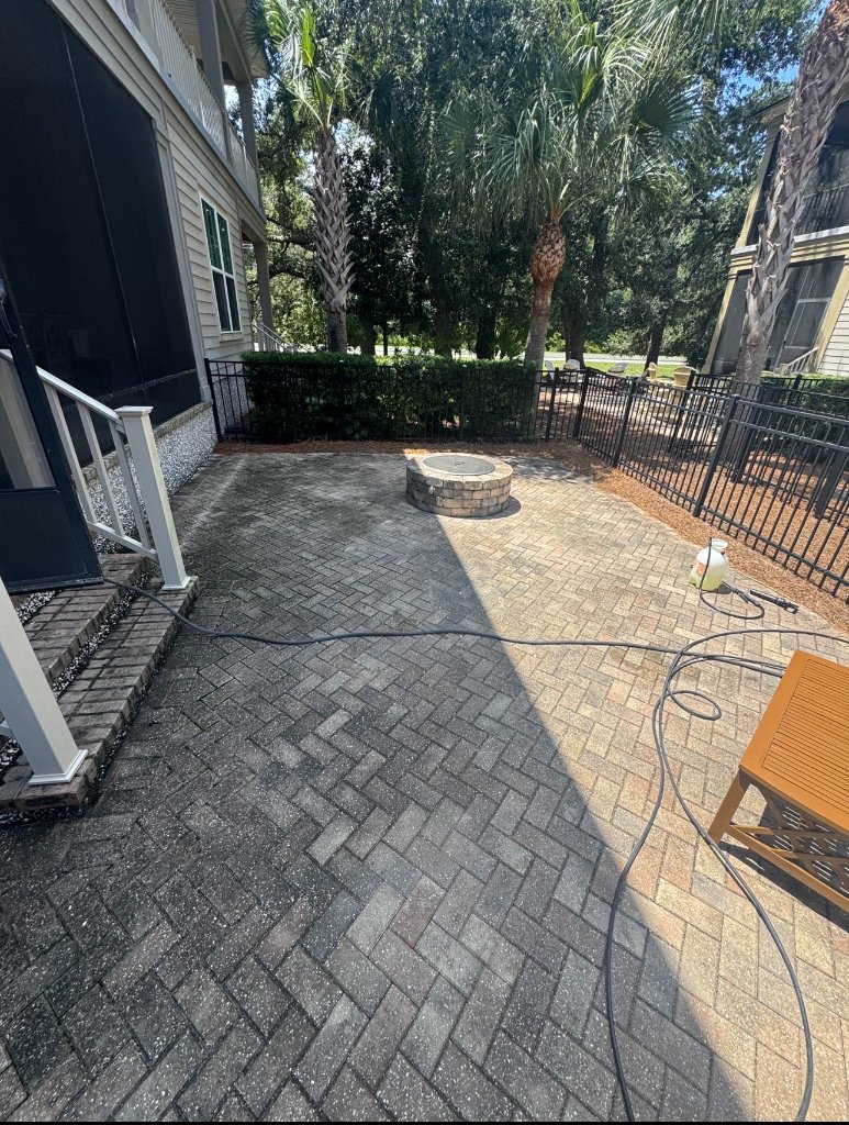 Stained and discolored patio with algae growth before Blueprint Construction pressure washing — Golden Isles, GA