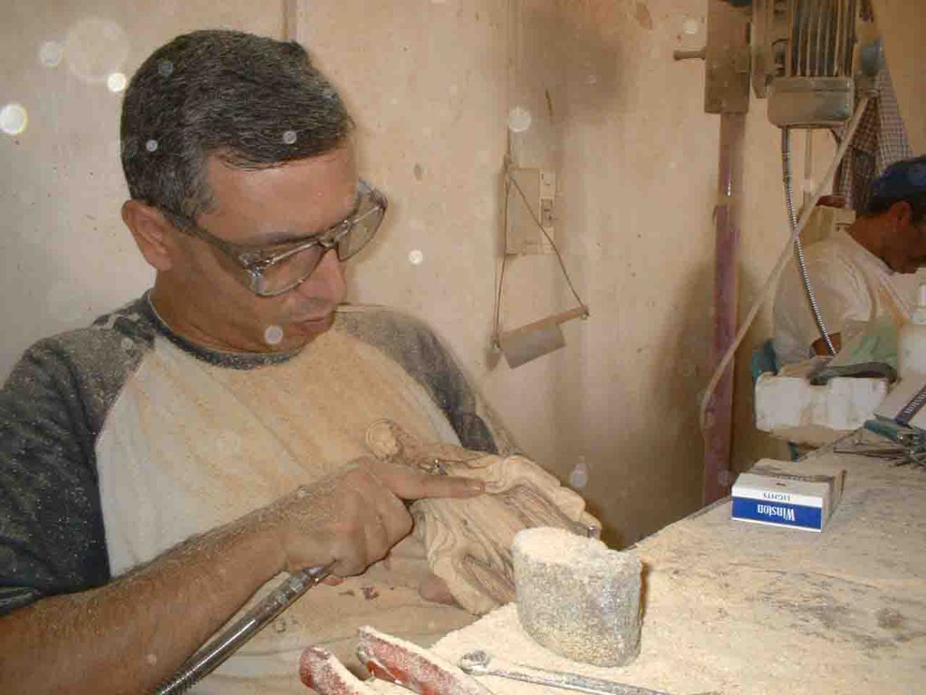 Hand-carved olive wood religious items including crosses and nativity scenes