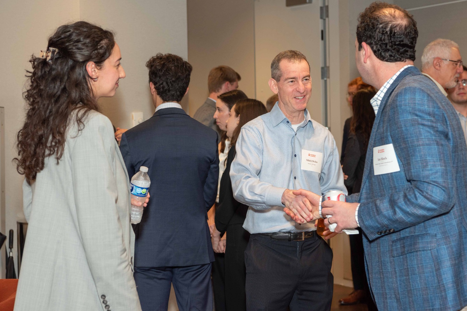 Two attendees shaking hands