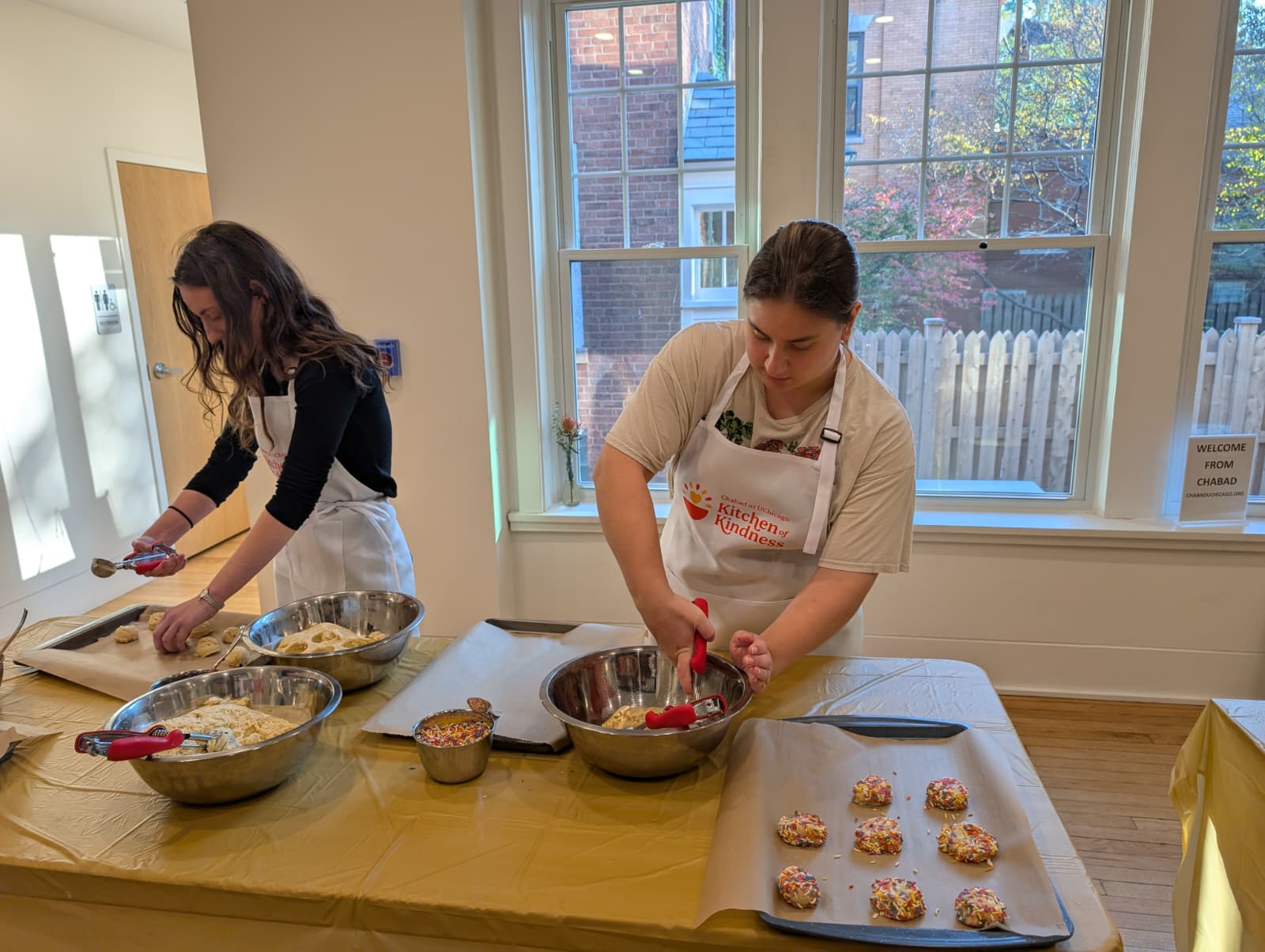 Volunteers preparing homemade treats together for Kitchen of Kindness