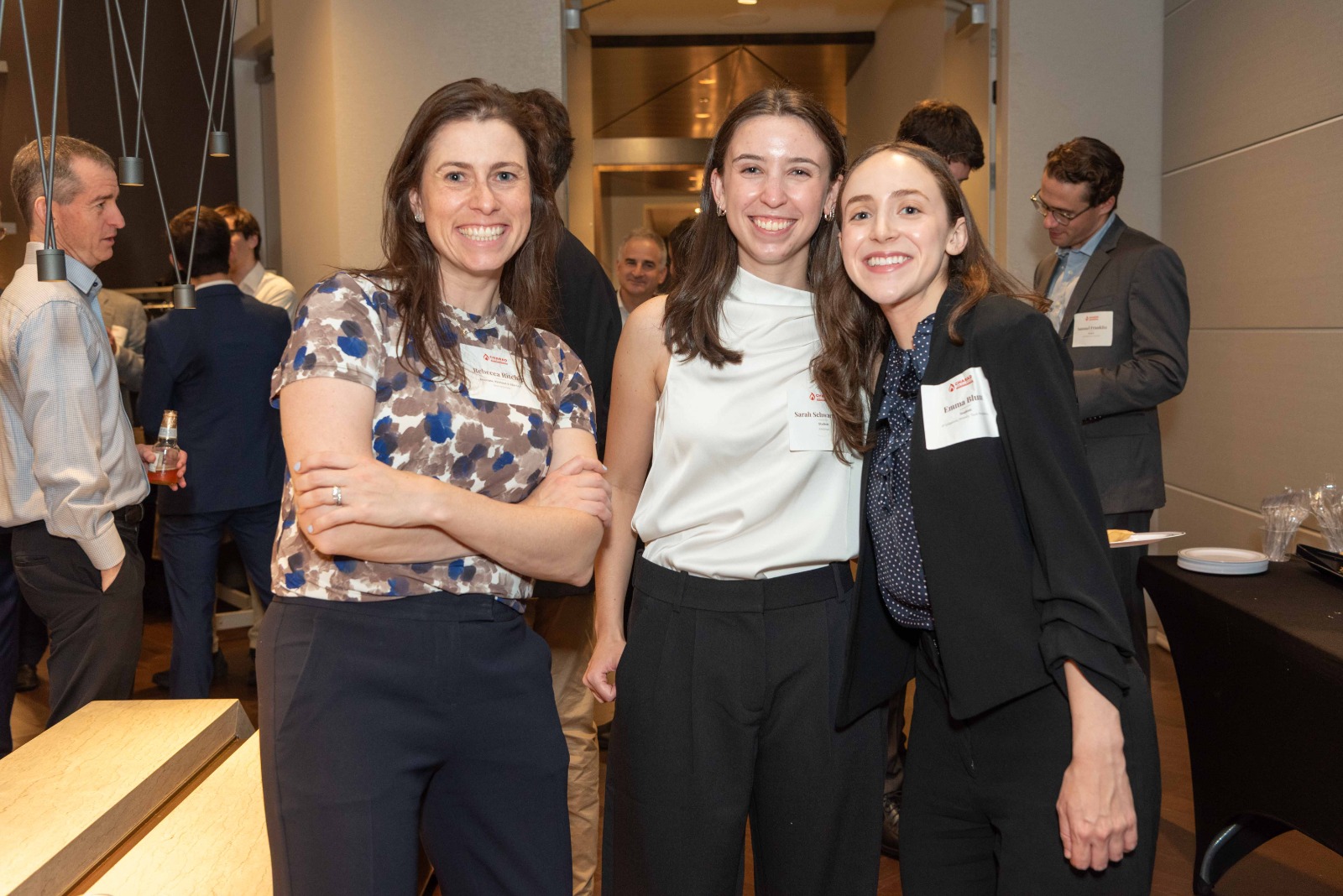 Three guests posing together at the mixer