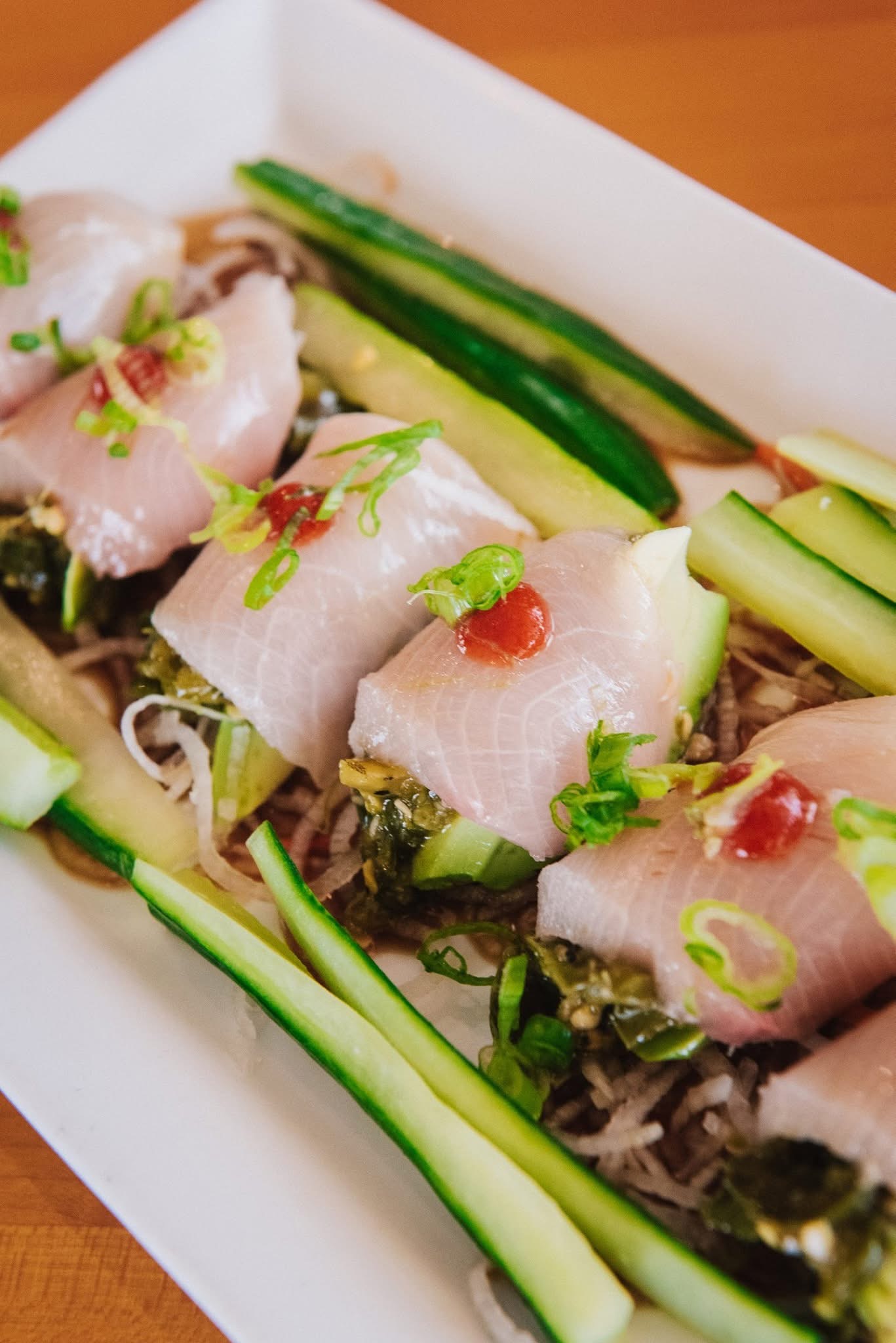 Yellowtail sashimi rolls with seaweed salad at Sushi Brokers