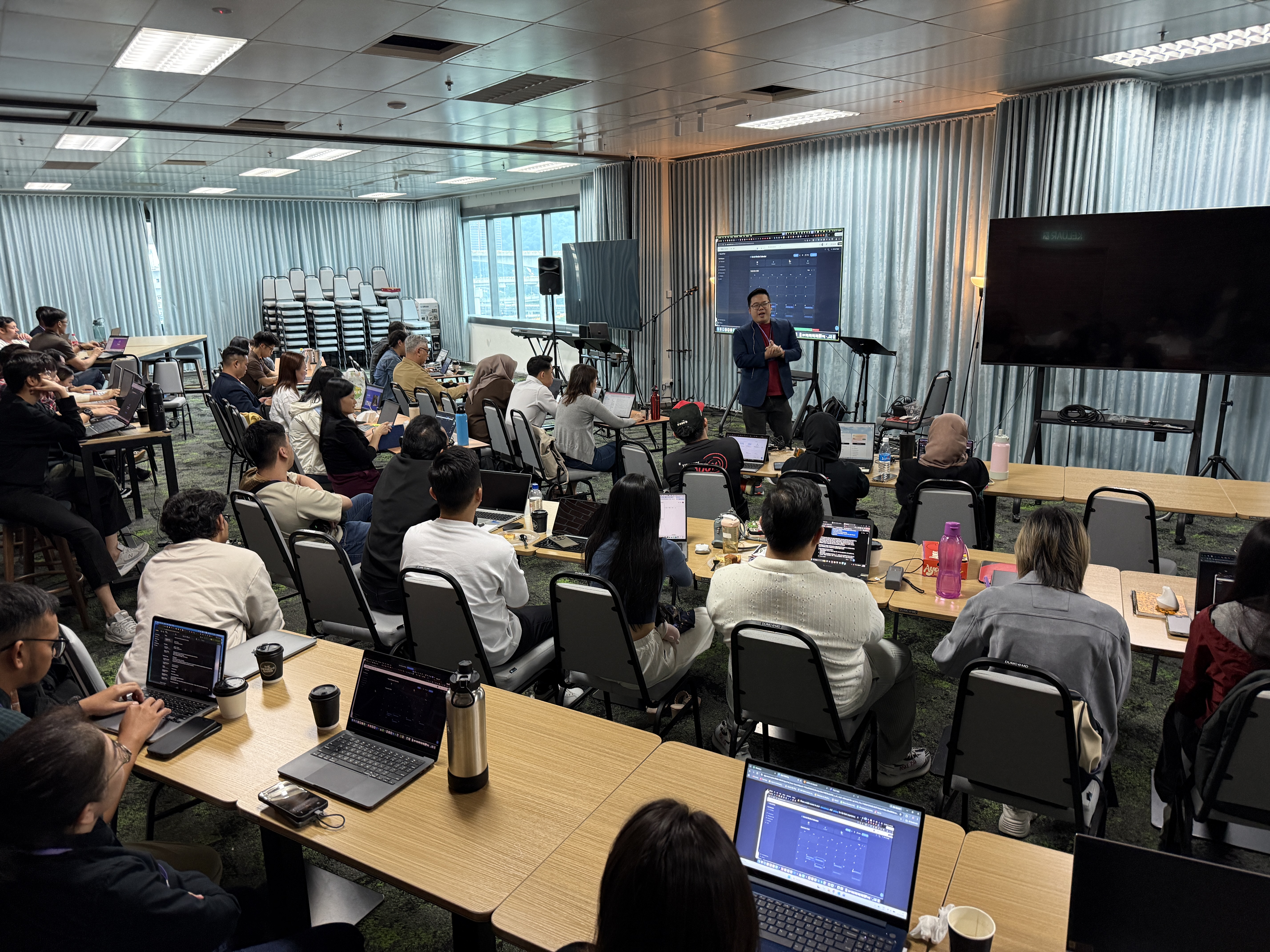 Eli Hong presenting at a corporate AI training event to a full room