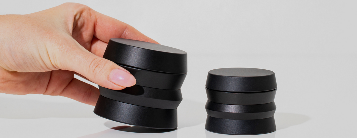 Two HØJ grinders, with one held in a hand