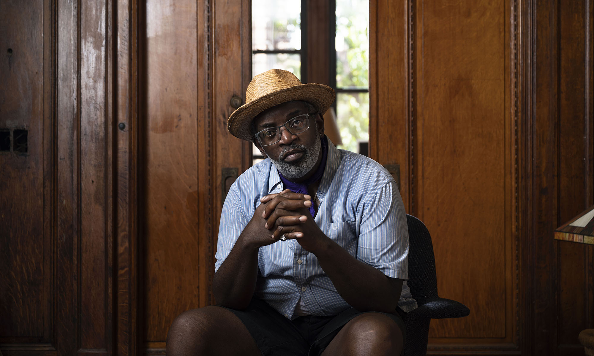 Fab 5 Freddy seated in a wood-paneled room