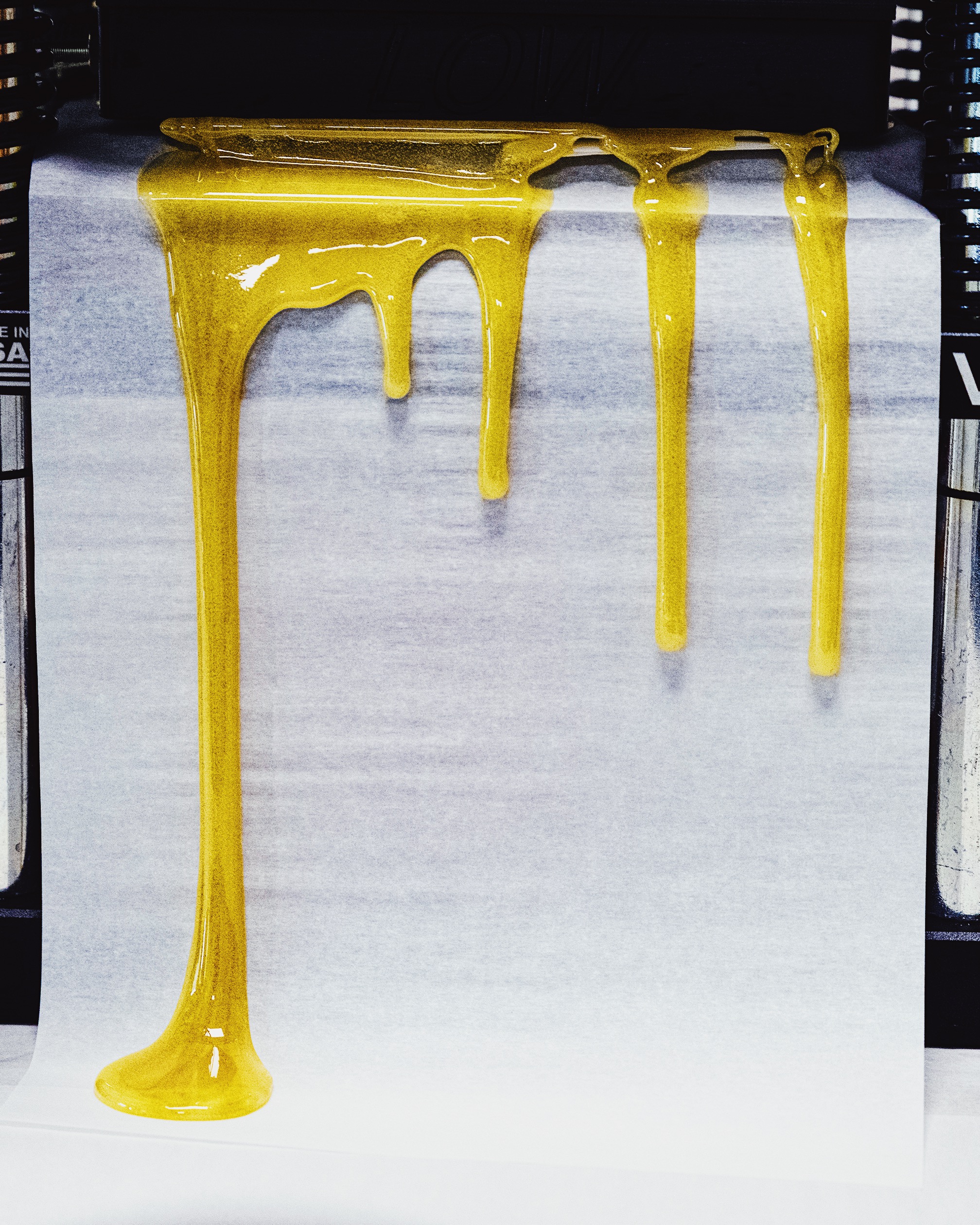 Golden concentrate ribbons on paper, shown in a fully framed High Rise archive photograph