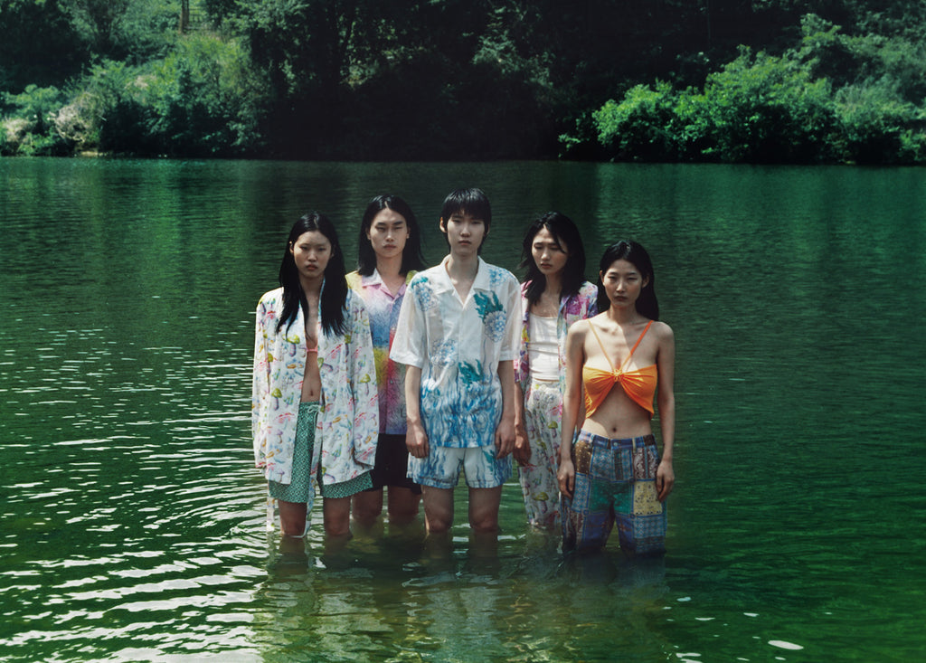 Five models in Sundae School clothing standing together in a lake