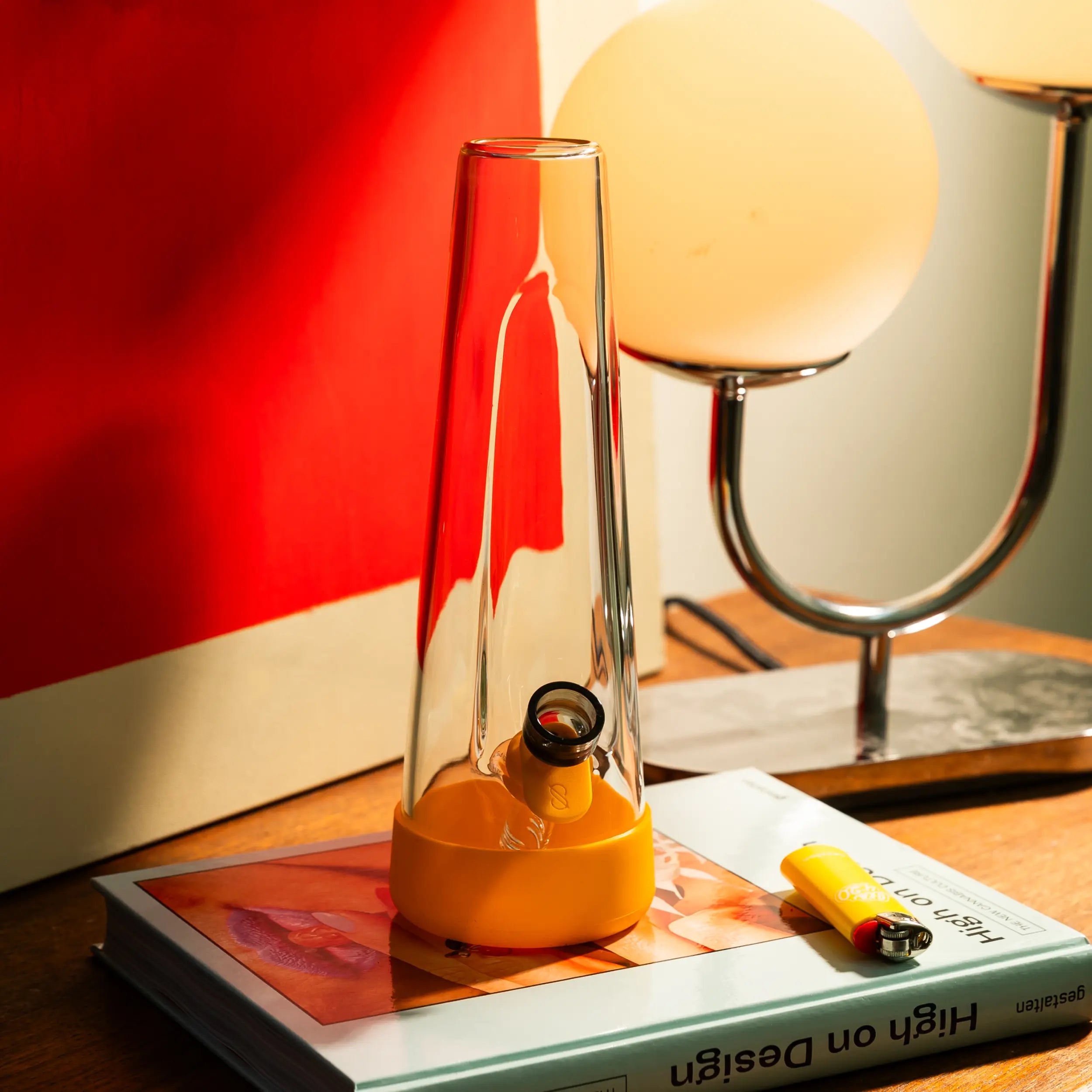 Clear Session Goods bong with Paradise yellow silicone accents on a side table