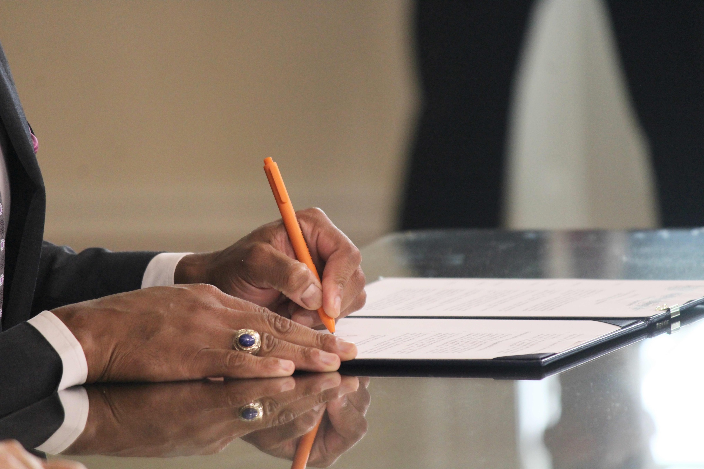 Hands using the Pen to Right History campaign pen