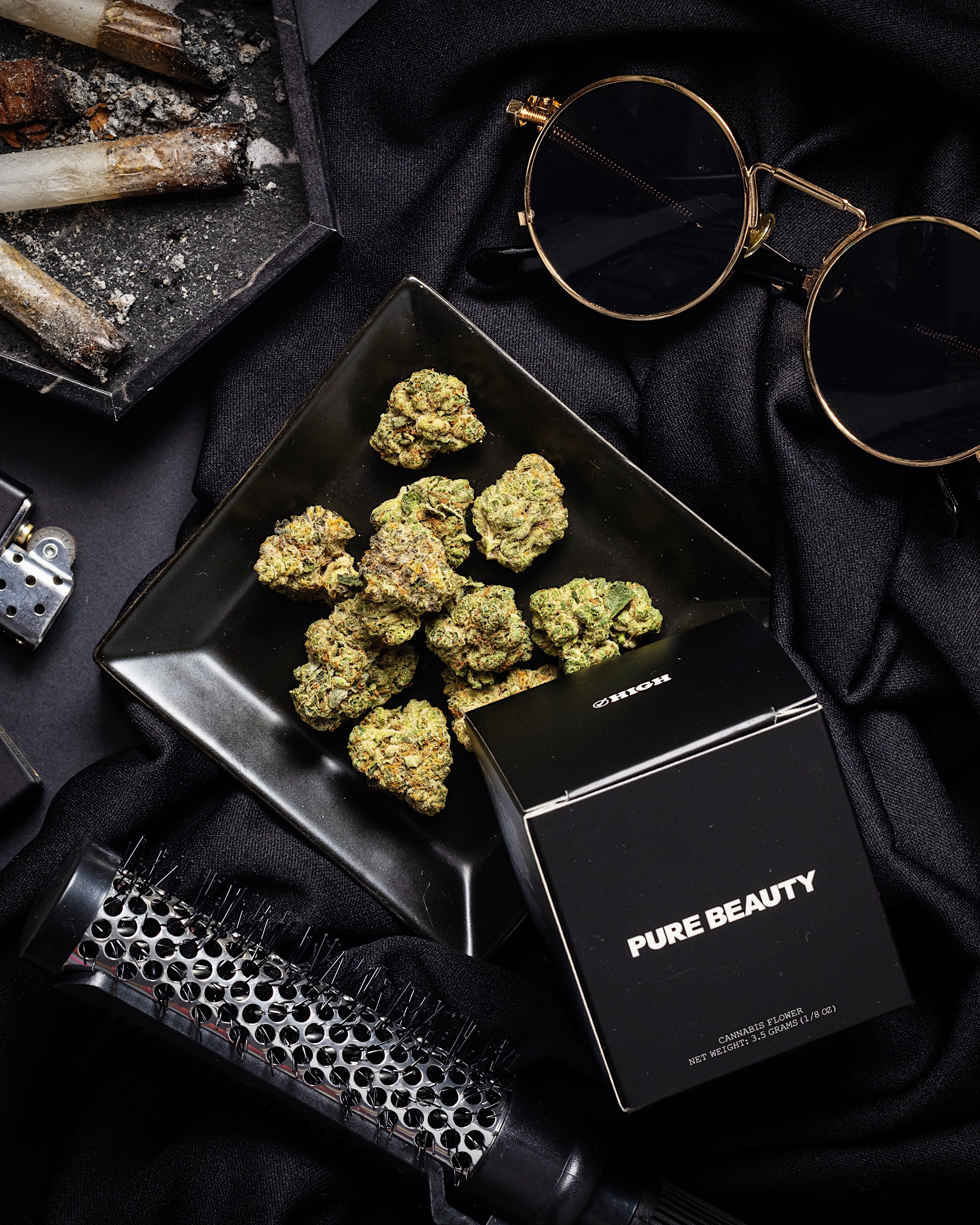 Pure Beauty flower and black packaging in a High Rise archive still life