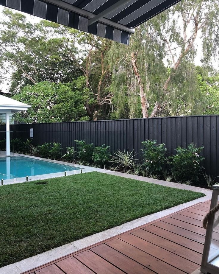 Black slat fence with pool area