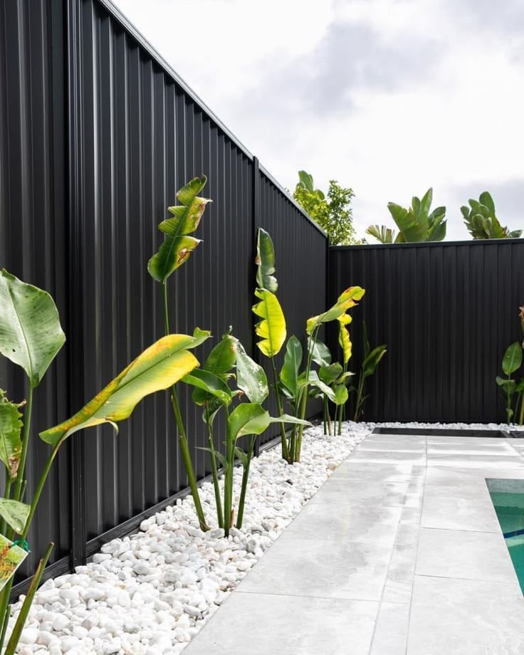 Colorbond fence with stone garden bed