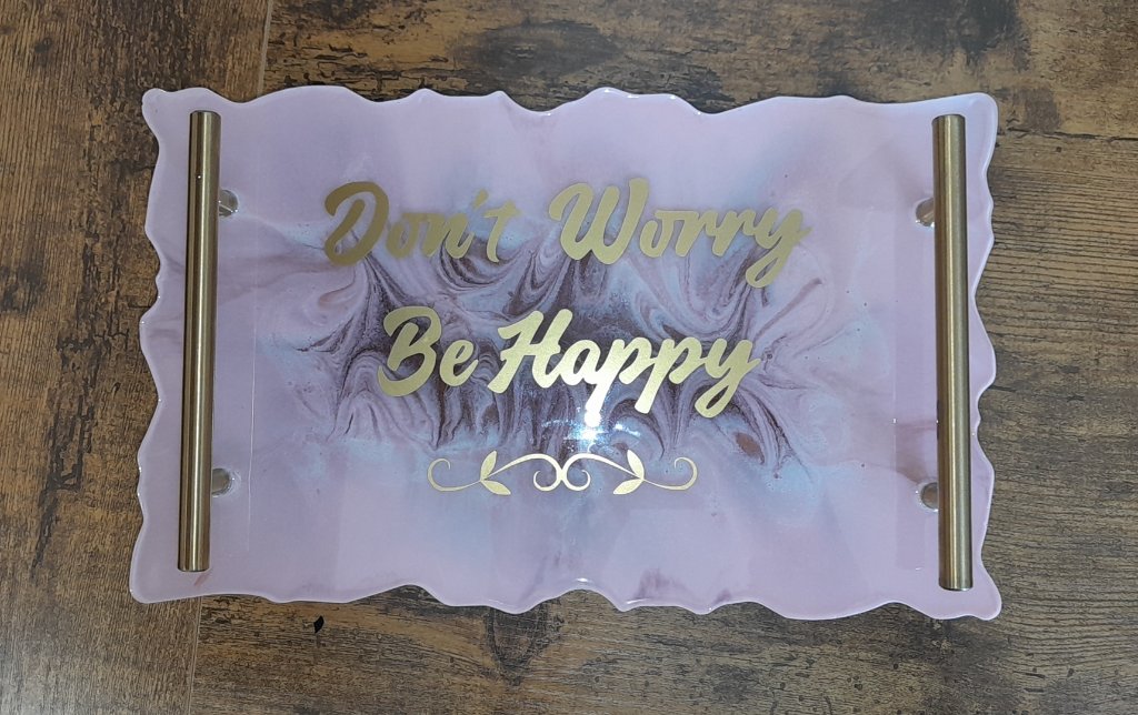 Pink resin tray with gold Dont Worry Be Happy lettering and gold handles