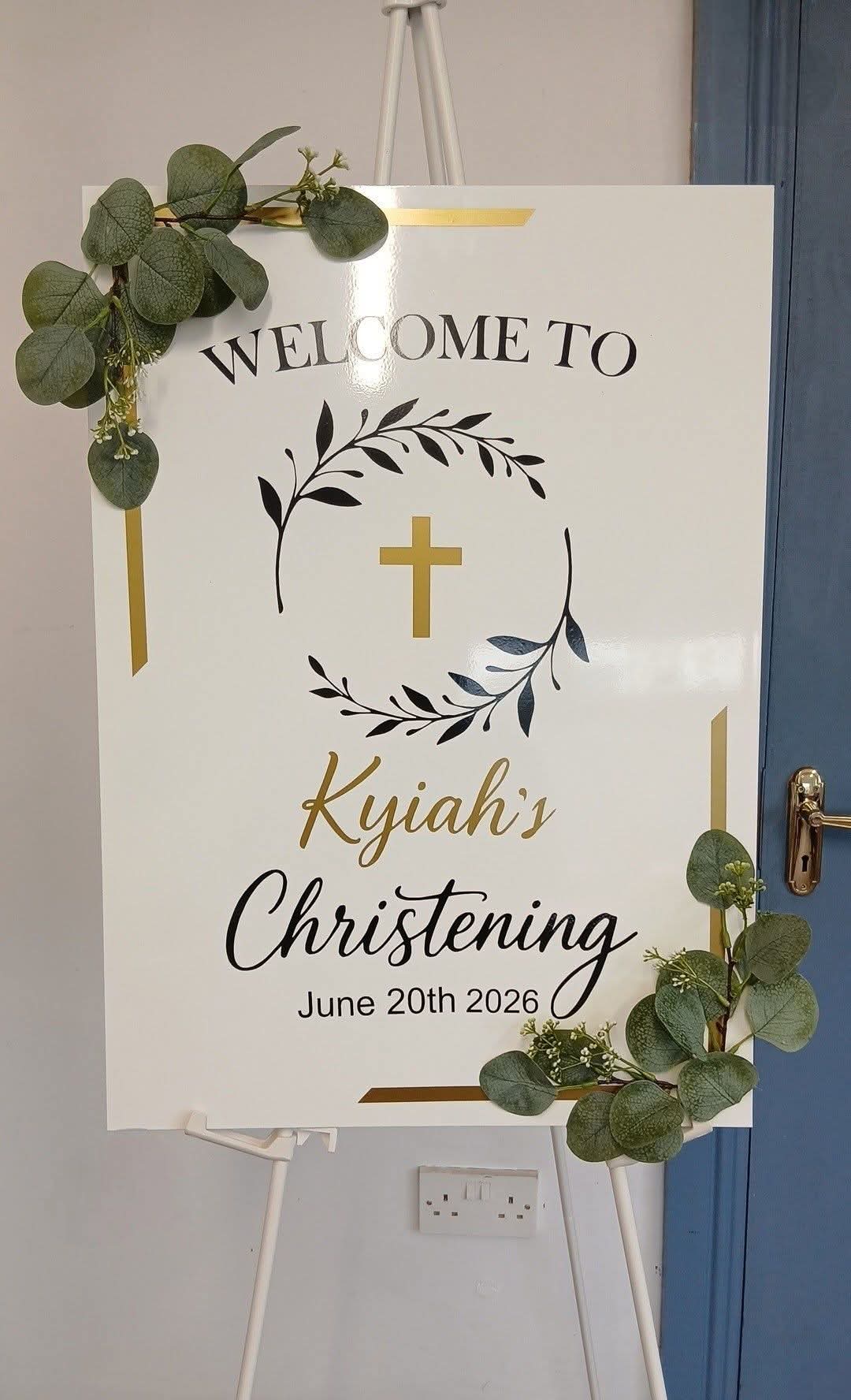 Kyiah's christening welcome sign with laurel wreath and gold cross