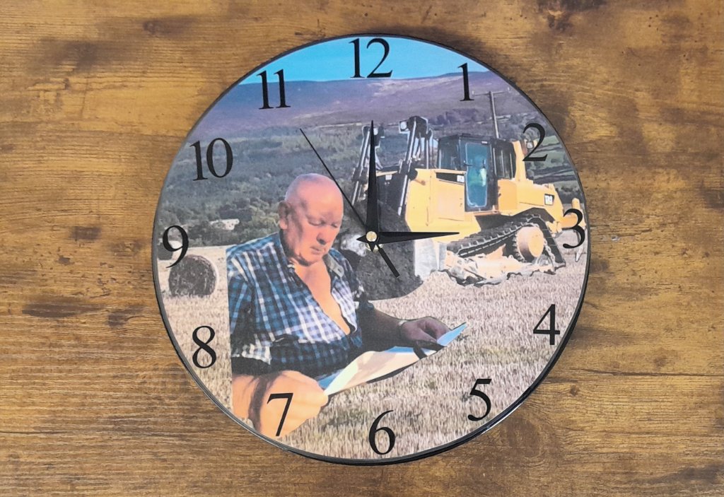 Round wall clock with bulldozer field portrait photo face on wood surface