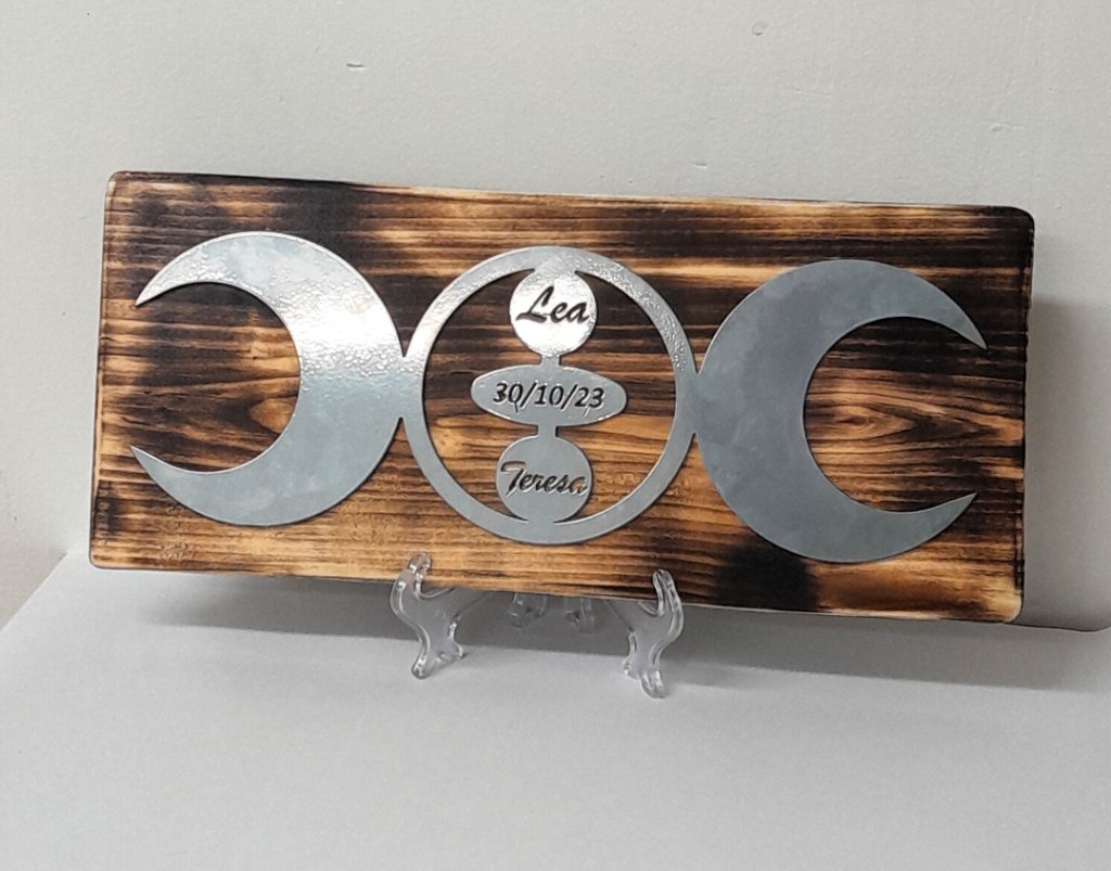 Lea and Teresa triple moon metal plaque on burnt wood