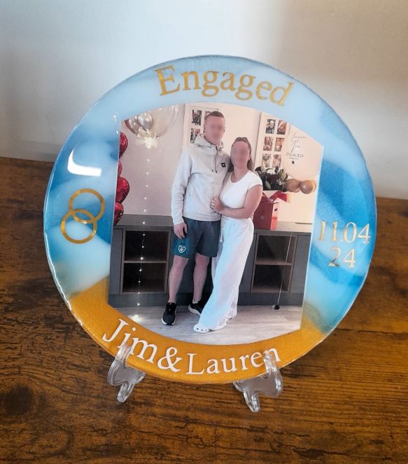 Circular resin engagement plaque for Jim and Lauren with blue and gold marbling