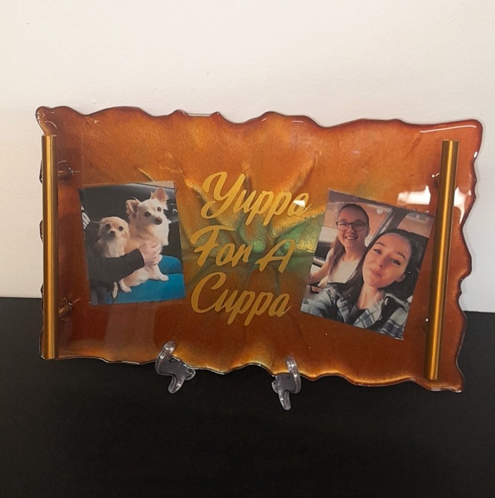 Amber resin tray reading Yuppa For A Cuppa with embedded photos and gold handles