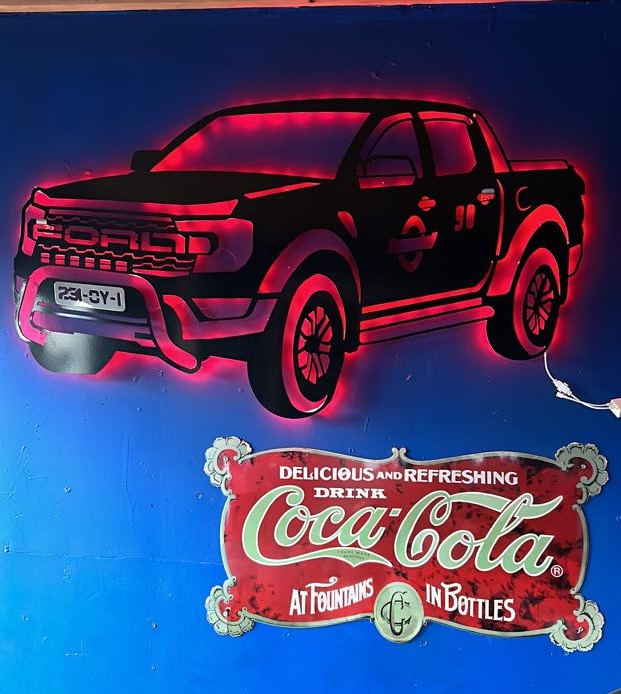 Ford Raptor LED wall art with red lighting and Coca-Cola sign