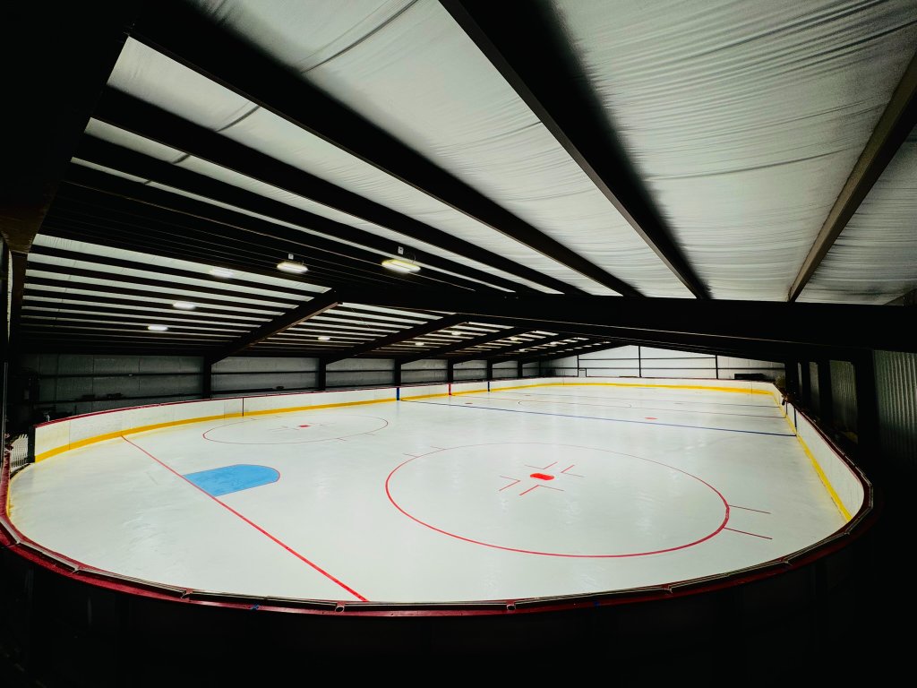 Energy Ice Den skating rink with pristine ice and blue lighting