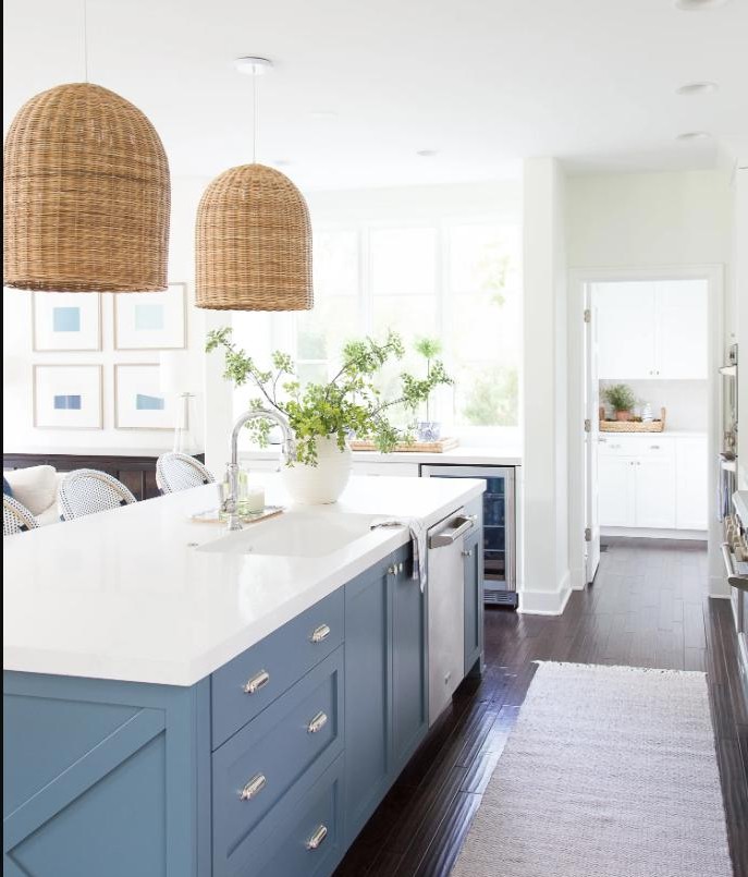 Custom kitchen renovation with white shaker cabinets, quartz island, and pendant lighting