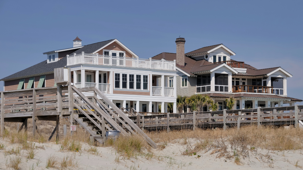 Elevated Lowcountry home with wraparound porch and coastal landscaping