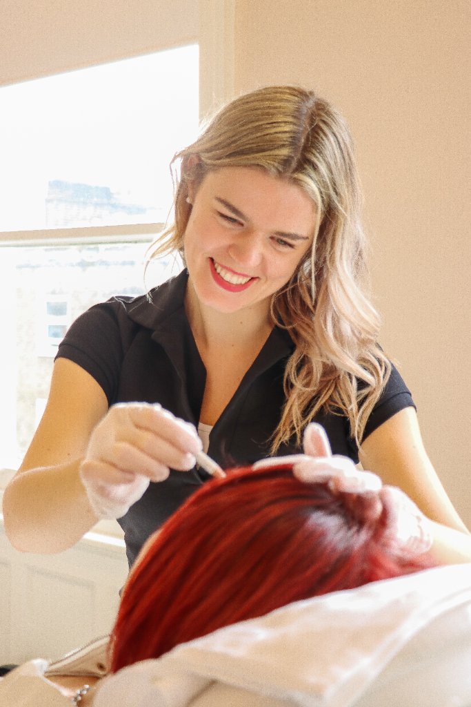 Practitioner performing a treatment at EC Clinic London