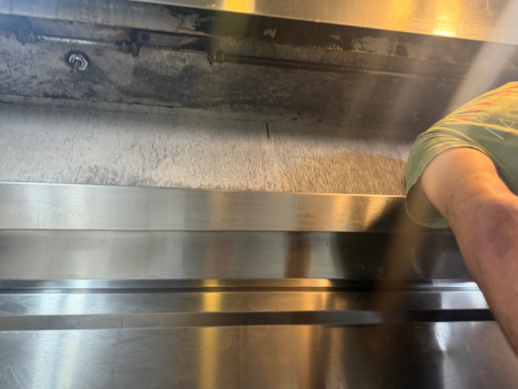 Technician cleaning hood