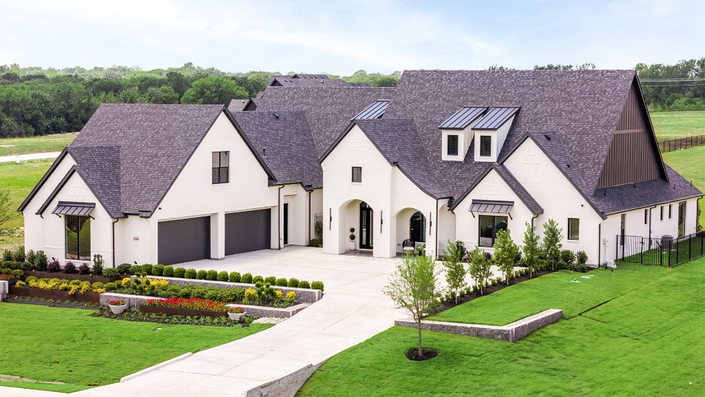 Redbud Gardens Celina Texas — custom luxury home by Homes by J. Anthony featuring white brick exterior, 4-car garage, and resort landscaping