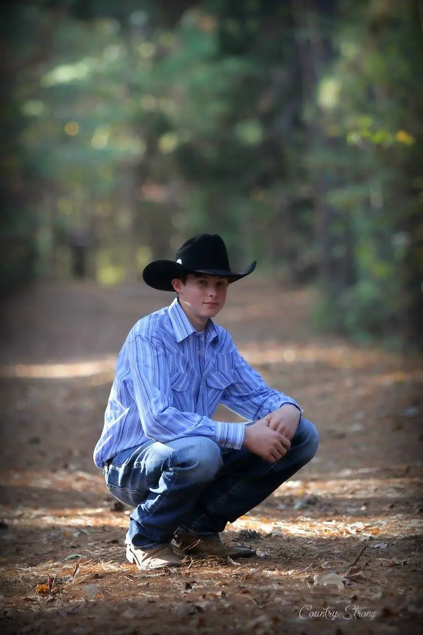 Senior portrait of a student in a hat, photographed on location