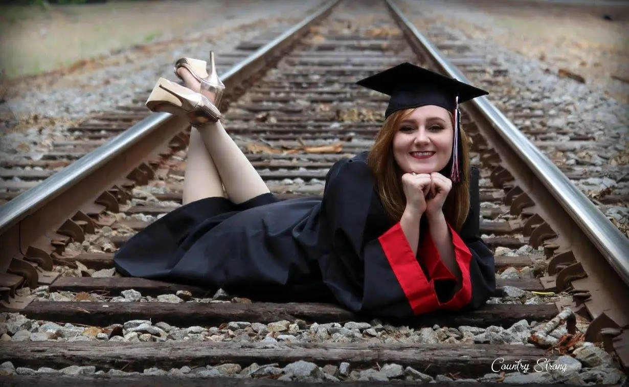 High school senior in cap and gown during her senior session