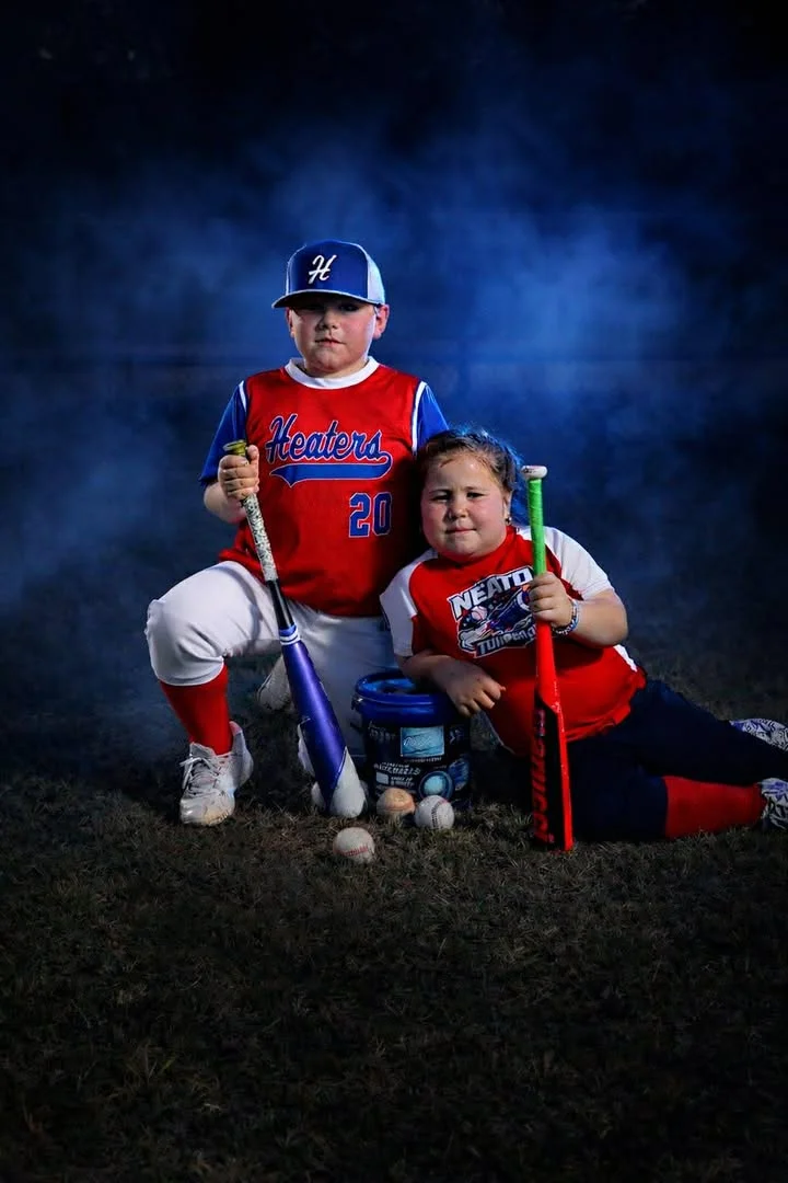Two baseball players posed with bats at a team Media Day