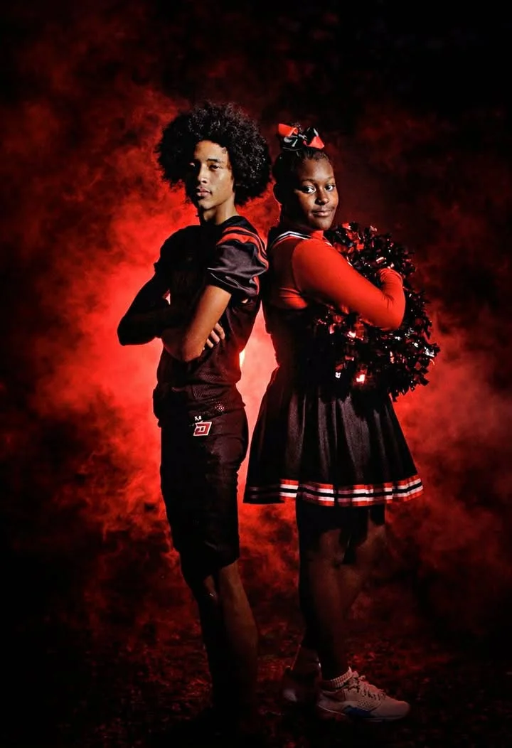 Football player and cheerleader photographed at a Country Strong Sports Media Day