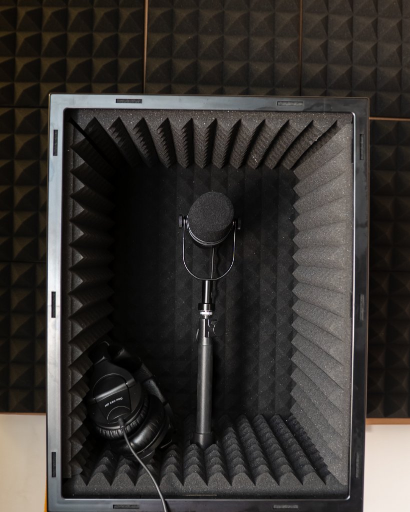 Recording booth with microphone and headphones