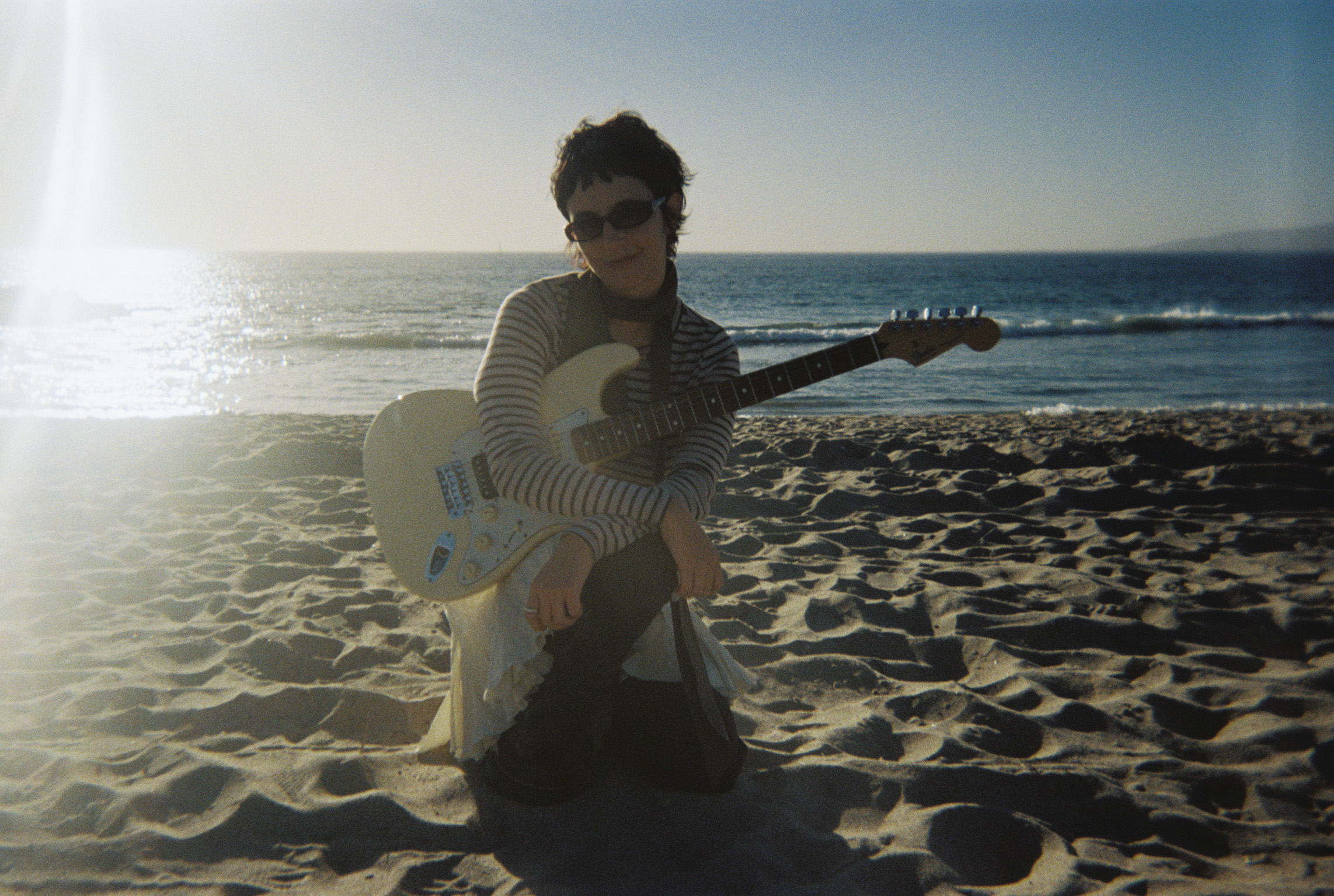 Winter on beach with guitar at golden hour